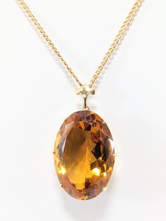 14 KT Gold Oval Citrine Pendant  Cuban Chain - 21.75" x 2mm  Fleur De Lis Bail Pendant - 19mm by 28mm Hallmark "14K " on Chain Total Weight: 11.4 DWT/ 17.7 Grams Please see our photos. Our shipping includes USPS First Class Mail with Insurance and Delivery Confirmation. All offers will be reviewed Monday through Friday from 9 AM-5 PM Formal Oval Amber Necklace, Gold Citrine Jewelry In Oval Cabochon Shape, Luxury Amber Oval Necklace, Amber Oval Necklace With Large Pendant, Formal Amber Necklace With Oval Pendant, Formal Amber Oval Pendant Necklace, Gold Oval Gemstones With Large Stone, Gold Jewelry With Large Oval Cabochon Stone, Oval Faceted Necklace In Fine Jewelry Style