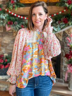 Look blooming fabulous in this Grace Multi-Floral Blouse! From the frill mock neck to the sheer bubble sleeves, this playful top will have you living your best floral fantasy. Plus, the smocked cuffs provide a flattering and comfortable fit. Get ready to brighten up the room! Relaxed fit. I am in the small. You can size down. Sizes: Small-Large 100% Rayon Follow tag instructions for washing. Feminine Fall Smocked Top With Floral Print, Feminine Floral Smocked Top For Fall, Floral Print Puff Sleeve Peasant Top For Brunch, Feminine Floral Print Peasant Top With Puff Sleeves, Chic Floral Print Top With Lantern Sleeves, Flowy Balloon Sleeve Top For Brunch, Multicolor Floral Print Top With Balloon Sleeves, Chic Smocked Lantern Sleeve Top For Spring, Casual Floral Print Peasant Top With Balloon Sleeves