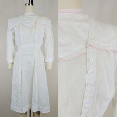 "Late 1910s(circa 1918) dress ~White linen/cotton ~Pink swiss dot scalloped trim ~Side front shell buttons Brand: none Hand washed and ready to wear. Condition: Very good. Some small holes and spots. Slight yellowing to edge of trim on neck band. Neck appears to have been let out at some point-one side of neck is unattached and will need to be pinned or a snap or hook added Size: Fits like a modern XS *please consult measurements to ensure fit Measurements Bust: 35\"(36\" snug) Waist: 25\" Hip: Fitted Cotton Prairie Dress For Daywear, Fitted Cotton Victorian Dress For Daywear, Fitted Cotton Vintage Dress For Daywear, Cotton Victorian Dress With Buttons For Daywear, Classic Victorian Dress With Lace Trim For Spring, Fitted Vintage White Dress For Daywear, Fitted White Vintage Dress For Daywear, Classic Cotton Prairie Dress For Daywear, White Fitted Cotton Victorian Dress