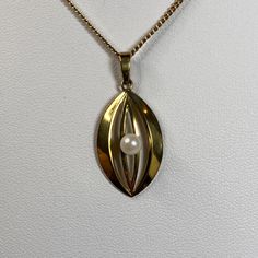 On offer today is a splendid vintage German designer 8K gold necklace by Friedrich Binder. The matching 8K pendant features a pretty cultured pearl. MARKINGS: 333 FBM on chain 333 G&K on pendant MEASUREMENTS: Sturdy curb link chain is about 21 inches long, and about 1.67mm wide. Pendant is about 1.5 inches long, by about 5/8 inch wide. Cultured pearl 5mm diameter. WEIGHT: 6.144g total Chain 4.149g Pendant 1.989g CONDITION: Good vintage condition! This will be great for wearing or gifting! Pearl is the birthstone for June, and 30th year anniversary. Great for Valentine's day, Mother's day, Graduation, or Christmas. What is 8K gold?? 8 karat gold is 33.3% pure gold in an alloy with silver and copper. Yellow gold color = about 33.3% of each metal. White gold color has a higher proportion of s Mid-century Gold Necklace Gift, Vintage Yellow Gold-plated Charm Necklaces, Modernist Hallmarked Yellow Gold Jewelry, Luxury Modernist Gold Necklace, 30 Year Anniversary, Yellow Gold-plated Vintage Charm, Pure Gold, Cultured Pearls, Gold Color