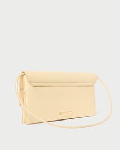 Hand-sewn flap shoulder bag in sweet butter yellow leather. Features a removable strap and exterior metal logo plaque. Beige Satchel Flap Bag With Magnetic Closure, Classic Cream Flap Bag For Evening, Classic Cream Leather Flap Bag, Beige Rectangular Flap Bag With Magnetic Closure, Beige Shoulder Flap Bag With Magnetic Closure, Beige Flap Bag With Magnetic Closure For Evening, Classic Beige Satchel With Magnetic Closure, Beige Evening Flap Bag With Magnetic Closure, Elegant Yellow Crossbody Flap Bag