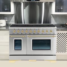 a kitchen with two ovens and a stove top in it's stainless steel cabinetry