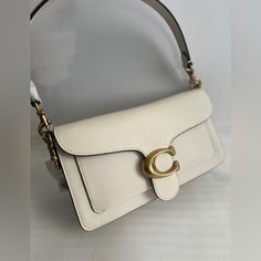 The Price Is Firm! Please Do Not Send Any Offer! Thanks! Polished Pebble Leather Inside Zip And Multifunction Pockets Snap Closure, Fabric Lining Outside Slip Pocket Detachable Short Strap With 7 3/4" Drop Detachable Long Strap With 21 1/4" Drop For Shoulder Or Crossbody Wear 10 1/4" (L) X 6" (H) X 3" (W) Style No. 73995 Luxury White Flap Bag For Office, Luxury Cream Flap Bag For Everyday Use, Luxury Cream Everyday Flap Bag, Classic White Flap Bag With Branded Hardware, White Clutch Flap Bag With Dust Bag, White Clutch Bag For Office, White Office Clutch Bag, Coach Cream Clutch Bag, White Flap Bag With Gold-tone Hardware For Daily Use