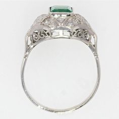 This is part of Chairish’s Fine Jewelry assortment.  Ring in 18 karat white gold, owl hallmark.  With a curved shape, this sublime antique ring is decorated with an degrees- cut emerald in closed setting on geometrical motives set with diamonds.  The basket is openwork.  Total weight of the emerald : 1.10 carat approximately.  Total weight of the diamonds : 0.25 carat approximately.  Height : 11.7 mm, width : 15.2 mm approximately, thickness : 6.8 mm approximately, width of the ring at the base Emerald Statement Ring, Antique Emerald Ring, 1950s Art, Gold Owl, Emerald Ring Vintage, Vintage Halo, Emerald Wedding Rings, Emerald Ring Gold, Emerald Wedding