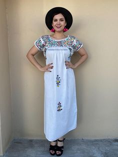 "Elegant dress and colourful hand-embroidery. Perfect for mexican weddings, mexican parties, etc. Made in the 80's Loose fit Fits size Small-Medium Measurements taken flat: Armpit to armpit 22\" Bottom hem width 26\" Shoulder to bottom hem 51 1/2\" Note: In the last pic shows a flaw the dress has, price has been reduced" Boho Short Sleeve Dress With Floral Embroidery For Beach, Short Sleeve Boho Dress With Floral Embroidery For Beach, Short Sleeve Peasant Dress For Vacation, Spring Peasant Dress With Short Sleeves, Bohemian Peasant Dress With Short Sleeves, Casual Short Sleeve Peasant Dress For Summer, Embroidered Boho Beach Dress With Short Sleeves, Summer Short Sleeve Peasant Dress For Beach, Short Sleeve Peasant Dress For Beach In Summer