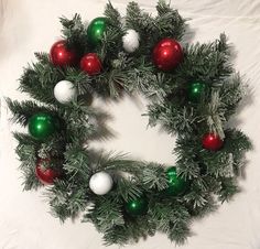 a christmas wreath with red, green and white ornaments