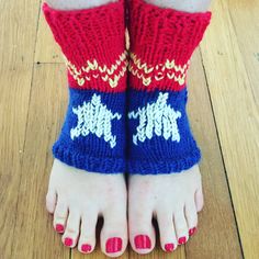 a woman's feet with red, white and blue knitted socks on them