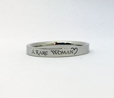 "This line of stainless steel rings (sizes 5-11) is engraved with \"A Rare Woman\" in a celtic font with a half heart design on one end. The ring is laser engraved permanently in black on the surface of the ring. --Choose from Silver, Gold, Rose Gold (all with black engraving) or Black- with silver engraving. --Rings come in a small gift box. This style stainless steel ring is 3mm wide - thin enough to wear multiples. PLEASE be sure of your ring size before ordering. If you're interested in your Engraving Rings, Celtic Fonts, Celtic Heart Knot, Half Heart, Celtic Heart, Ring Spacer, Small Gift Boxes, Silver Engraving, Stainless Steel Ring