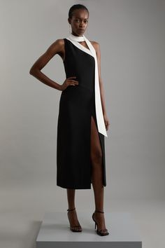 Embrace Elegance In Our Asymmetric Midi Dress, Designed With A One-Shoulder Silhouette And Thigh-High Split. The Unique Shoulder Tie Offers Versatility, Allowing You To Drape It Gracefully Around Your Neck Or Shoulders, Or Tie It Into A Statement Bow. Complete Your Look With Strappy Heels And A Clutch To Make It The Perfect Outfit For A Special Occasion Or A Romantic Date Night. Soft Tailored Asymmetric Midi Dress One Shoulder With Tie Detail Thigh High Split Flattering Soft Tailored Fit Midi Le Asymmetrical Dresses, Romantic Date Night, Soft Tailoring, Dress One Shoulder, Nice Clothes, Romantic Date, Tailored Dress, Karen Millen, Rehearsal Dinner