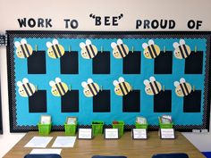 a bulletin board with bees on it in the middle of a classroom setting for work to bee proud of