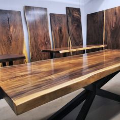 a wooden table with chairs in front of it