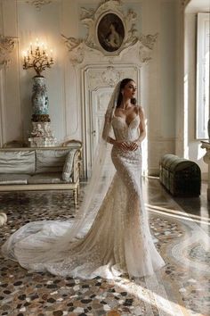 a woman in a wedding dress is posing for the camera