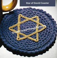 a crocheted star of david coaster on a table