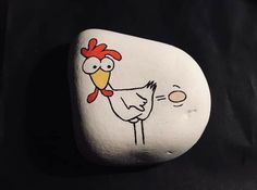 a painted rock with a chicken on it