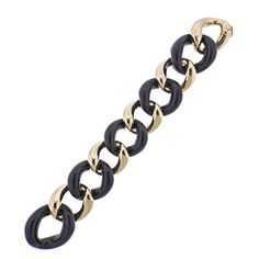 Brand new Seaman Schepps large link bracelet in 18k gold with ebony wood. Comes with box. DESIGNER: Seaman Schepps MATERIAL: 18k Gold GEMSTONES: Wood DIMENSIONS: Bracelet is 7.75" long end to end, wearable length is approx. 7. - 7.25", width 33mm. MARKED/TESTED: 750, 242373 Z, Shell hallmark, Seaman Schepps. WEIGHT: 76.4 grams CONDITION: Brand New Elegant Black Link Chain Bracelet, Elegant Black Chain Bracelets, Elegant Black Chain Bracelet, Elegant Black Link Jewelry, Black Link Jewelry For Formal Occasions, Modern Black Chain Bracelet For Formal Occasions, Classic Black Chain Bracelet For Formal Occasions, Luxury Black Chain Bracelet For Formal Occasions, Classic Black Jewelry With Gold Chain