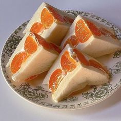 four slices of orange cheesecake on a plate