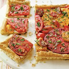 four slices of tomato tart with herbs on top