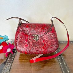 MADE IN MEXICO By: Mexican Artisans For: Women Color: red Dimensions: 9.5 x 8 x 2.5 Details: 100% Authentic Leather Style: Crossbody | Shoulder Bag Embossed Design Hook lock closure Adjustable & Non-Removable Strap: 22" Drop Contact us for more detailsPLEASE READ BEFORE PURCHASE: The picture is an ACCURATE REPRESENTATION.Colors in the pictures may vary a little by effects of light. Each product is handmade from Mexico causing differentiation and minor imperfections in each piece making them that Red Crossbody Bag With Magnetic Closure, Red Flap Bag With Mobile Phone Pocket For Travel, Red Flap Bag With Mobile Phone Bag For Travel, Red Flap Bag With Mobile Phone Holder For Travel, Red Crossbody Flap Bag, Red Satchel Shoulder Bag With Mobile Phone Pocket, Red Rectangular Satchel With Magnetic Closure, Red Rectangular Bag With Magnetic Closure, Red Rectangular Flap Bag With Mobile Phone Holder