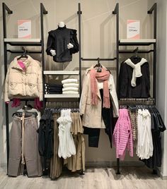 the clothing rack is full of clothes and coats for women to wear in winter or fall