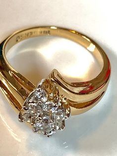 Zirconia and 18k GE ring, signed size 9 Formal Bypass Ring With Prong Setting In Cubic Zirconia, Vs Clarity Cluster Promise Ring, Classic Cubic Zirconia Bypass Ring For Formal Occasions, Formal Diamond Rings Stamped 14k, Dazzling Hallmarked Cluster Ring For Formal Occasions, Cluster Diamond Ring With Vs Clarity For Anniversary, Vs Clarity Cluster Diamond Ring For Anniversary, Gold Bypass Ring With Round Cut For Formal Events, Oval Cluster Ring With Vs Clarity For Anniversary