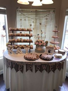 a table topped with lots of cupcakes and cakes