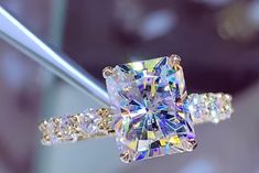 a diamond ring is being held by a needle