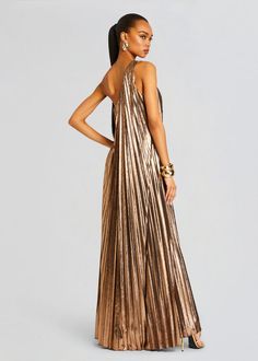 Dazzle in our stunning Kensley Dress, designed with a flattering one-shoulder neckline and cascading pleats for an effortlessly elegant look. Perfect for formal events, evening soirées, and special occasions, this flowing gown is sure to turn heads. Shown here in Metallic Bronze. 95% Polyester, 5% Spandex Made in China Flowing Gown, Bridal Reception Dress, Dress Night Out, Destination Dress, Bride Bachelorette, Bachelorette Party Bride, Spring Knits, Rehearsal Dress, Reception Dress