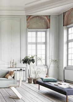 a living room with white walls and wooden floors