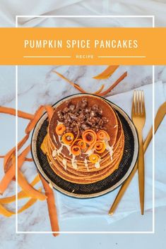 a pumpkin spice pancakes recipe on a plate with gold forks and orange streamers around it