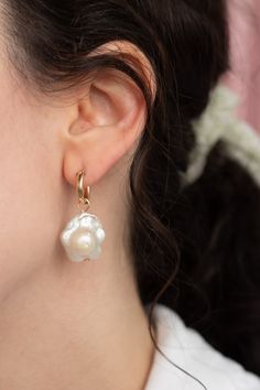 These daisy shaped freshwater pearl earrings are a unique spin on the classic Baroque pearl drops — Each set of pearls are different and won't look exactly like the ones pictured due to the nature of freshwater pearls. Choose from the drop-down menu if you want 14k gold-filled huggies hoops included, or just the charms alone. Each item is made-to-order. Please allow a processing time of 14 business days. We value your patience and appreciation of the handmade process! Delicate Baroque Pearl Earrings With Pearl Charm, Flower Shaped Pearl Charm Jewelry, Floral Pearl Charm Jewelry, Delicate Pearl Drop Earrings With Flower Shape, Delicate Pearl Drop Earrings In Flower Shape, Delicate Flower Shape Pearl Drop Earrings, Pear-shaped Akoya Pearl Earrings With Pearl Charm, Teardrop Baroque Pearl Earrings With Pearl Charm, Flower Shaped Pearl Earrings With Pearl Drop