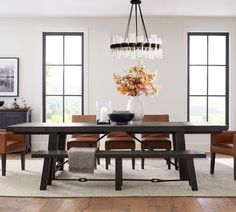 a dining room table with chairs and a chandelier