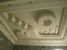 the ceiling in this room is made of white plaster and has round windows on each side