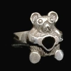 "A Vintage Sterling Silver Teddy Bear Holding a Heart Ring. The Ring is a Beautifully Crafted Functional Work of Jewelry. A Ring created around the 1970's. Size 7.75 Weight 3.7g Widest Part of Ring 5/8\" Thinnest Part of Band 1/8\" Rings are delivered in a Gift Box Free Domestic USA Shipping & Free Postal Insurance $5 Discount on International Shipping If you do not want the ring polished and want to leave the natural patina please let me know at the time of purchase as I do polish rings bef Teddy Bear Ring, Bear Ring, Holding A Heart, Friendship Ring, Friendship Rings, Gift For Daughter, Love Ring, Vintage Sterling Silver, Heart Ring