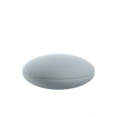 a round pillow sitting on top of a white surface