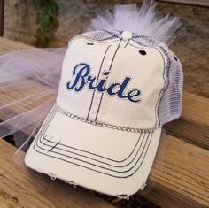 "Custom Bride Hat for Baseball Bachelorette Party or Bridal Shower- Customized to match her favorite team font and colors! I can match any team Makes a perfect gift for Bride! My Baseball theme Bride caps come with veil and customized in her favorite Baseball Team Colors. Perfect accessory to wear to a bachelorette party/bridal shower at a Baseball Game! Team Bride Hats also available message me for package deals@ OTHER BRIDE HAT STYLES AVAILABLE CLICK HERE https://www.etsy.com/shop/CapsbyKari?s Customizable White Hats For Sports Events, Personalized White Trucker Hat For Sports Events, Personalized White Baseball Cap For Sports Events, White Personalized Hat For Baseball Season, Customizable White Hats For Fan Gear, Customizable White Trucker Hat For Sports Fans, Baseball Bachelorette Party, Baseball Bachelorette, Bride Hats