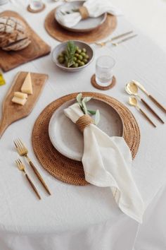 the table is set with plates, silverware and napkins for dinner or brunch