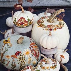 several painted pumpkins sitting on top of each other