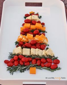 a christmas tree made out of cheese and tomatoes