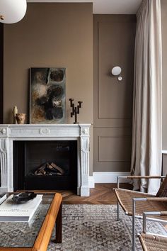 a living room with a fireplace and chairs