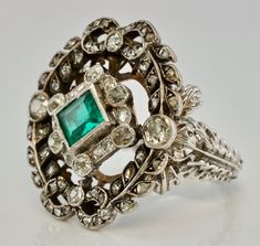 Art Deco Ring, Genuine Emerald Ring, Natural Diamond Ring, May Birthstone & 14K White Gold c.1920, Elegant Ring, Vintage Ring. This stunning estate ring is finely crafted in solid 14K White Gold and set with genuine Earth mined natural emerald and genuine diamonds. The center bezel set Emerald measures 5mm x 4.5mm (about .35ct). This is a very clean and transparent emerald with amazing intense green color with Natural inclusions. There are 56 natural diamonds in this ring for the total weigh Emerald Ring With Intricate Design, Fine Jewelry Emerald Ring With Intricate Design, Art Deco Emerald Ring With 17 Jewels, Art Deco Emerald Ring Collectible, Vintage White Gold Emerald Ring With Diamond Cut, Art Deco Green Emerald Ring With Rose Cut Diamonds, Art Deco Emerald Ring With Rose Cut Diamonds, Antique Hallmarked Emerald Ring, Antique Emerald Cut Emerald Ring With Center Stone