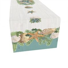 a table cloth with seashells and starfish on the bottom, along with palm leaves