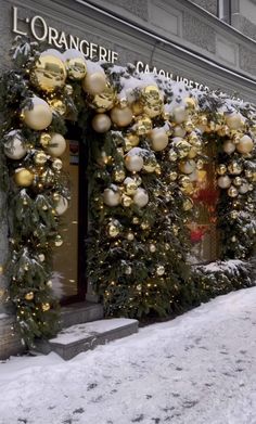 christmas decorations adorn the entrance to an orangerief department store in new york city