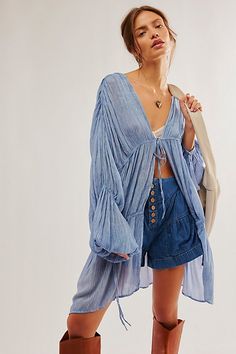 Add the loveliest layer to any look with this so cool kimono featured in a drapey, tiered design and pleated fabrication with exaggerated, billowy sleeves for added shape. **Features:** Relaxed fit, front-tie closure, pleated style, elasticated detail at wrists **Why We ❤ It:** Sure to be a go-to throw-on-and-go staple from season to season. **Fit Note:** This style may small, so we recommend sizing up if a more oversized, slouchy fit is desired. | Juliet Kimono by Free People in Blue Boho Festival Outfit, Free People Kimono, Kimono Outfit, Free People Style, Free People Clothing, Boho Kimono, Faded Denim, So Cool, Kimono Fashion