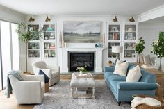 a living room filled with furniture and a fire place in front of a painting on the wall