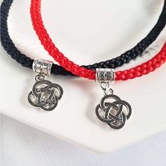 "This lucky knot Asian/Chinese style choker necklace is woven in a Kumihimo style flat braid band with 8 strands of 1mm thick satin thread in red or black color(custom colors available accented with a silver lucky knot charm and matching adjustable chain/lobster clasp.  The size range is 15\" to 17\".  For customized sizes, or custom colors please send me a message. Please have a look at my other EIGHT STRANDS Collections!  All designs are created by weaving a quantity of EIGHT pieces of string -  8, 18, 28...etc.  The number EIGHT is considered very LUCKY in Chinese because it is similar in sound to the word for FORTUNE and SUCCESS.  So I hope I can send a little luck and positive energy with each piece that I create! My designs are Asian-inspired, based on my experiences living in Hong K Silver Braided Jewelry For Friendship, Adjustable Braided Red Jewelry, Braided Nylon Cord Jewelry Gift, Braided Nylon Cord Jewelry As Gift, Braided Nylon Cord Jewelry For Gifts, Red Braided Jewelry As A Gift, Red Braided Jewelry For Gifts, Red Braided Jewelry Perfect As A Gift, Year Necklace