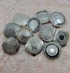 a bunch of silver plates sitting on top of a table