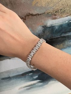 "Valentine's Day is around the corner. Is there anything that catches your eye?  Elegant Jewelry - everybody deserves that little elevation to their look without breaking their bank and this CZ Baguette bracelet is the most elegant addition yet!  Just added and currently on sale for the 4th of July weekend!  This tennis bracelet is standard size. It is made of 925 sterling silver,  featuring a setting of high quality simulated diamonds. Sizing: This cubic zirconia baguette bracelet comes in a standard size that aims to fit a range of wrist sizes. It is featured on a 6\" wrist.   Materials:  - Sterling Silver  - High Quality Simulated Diamonds (known as: Cubic Zirconia, CZ) Care Details: It is advised to wear it with care for the longevity of the piece. It is advised for it to remain away f Baguette Bracelet, Bracelet Tennis, Wedding Jewelry Bracelets, Types Of Lighting, Silver Gifts, Wedding Bracelet, Elegant Jewelry, Tennis Bracelet, Sterling Silber