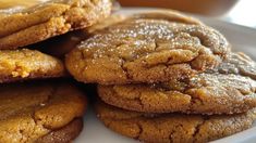 several cookies are stacked on top of each other in a white plate with gold flecks