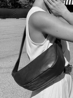 The Soft Crescent Bag from St. Agni is a petite carry-all design and a new season staple for someone on the go. Intended to be worn cross body or over the shoulder for an effortless look, this bag is a staple for any capsule wardrobe. The Soft Crescent Bag features a relaxed structure, a single shoulder strap, seam detailing, and a secured zipper closure. Pair the Soft Crescent Bag with our Stella Waffled Cotton Top and our Bobbie Wrap Skirt in Vintage Wash Modal for a time-honored look. Handmad Modern Shoulder Bag With Single Strap For On-the-go, Modern Leather Baguette Bag For On-the-go, Modern Large Capacity Crossbody Saddle Bag, Casual Tote Baguette Bag For On-the-go, Versatile Leather Baguette Bag For Travel, Casual Leather Baguette Shoulder Bag, Casual Soft Leather Satchel For On-the-go, Everyday Versatile Soft Leather Baguette Bag, Modern Everyday Crossbody Saddle Bag