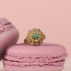 Immerse yourself in the opulent charm of the Victorian era with this breathtaking 14K yellow gold Cluster Ring adorned with a medley of colored pearls ranging from creamy hues to elegant grays, with a beautiful Turquoise as the center piece. This ring captures the essence of Victorian elegance and showcases a harmonious fusion of colors and textures. Each pearl possesses its unique luster and texture, adding depth and character to the overall composition.  At the heart of this magnificent cluste Heirloom Multi-stone Pearl Ring Gift, Heirloom Multi-stone Pearl Ring As Gift, Heirloom Cabochon Emerald Ring For Wedding, Heirloom Cabochon Emerald Wedding Ring, Heirloom Emerald Cabochon Wedding Ring, Elegant Green Gemstone Pearl Ring, Elegant Green Pearl Ring With Gemstone, Heirloom Multi-stone Pearl Wedding Ring, Heirloom Multi-stone Pearl Ring For Wedding